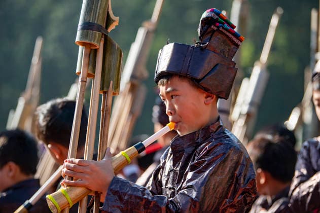 CONGJIANG, CHINA - NOVEMBER 25: Students of the Dong ethnic group in traditional costumes blow Lusheng, a traditional reed-pipe wind instrument, to celebrate the opening ceremony of the winter sports meeting at a primary school on November 25, 2025 in Congjiang County, Qiandongnan Miao and Dong Autonomous Prefecture, Guizhou Province of China.  Copyright: xVCGx 111605925908