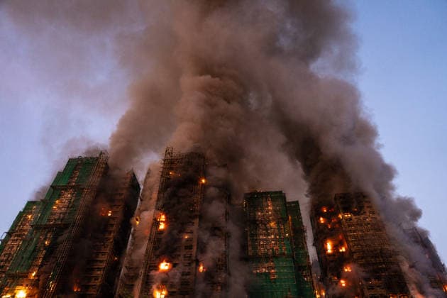 Hong Kong Building Fire Smoke and flames rise as a major fire engulfs several residential buildings at Wang Fuk Court on November 26, 2025 in Hong Kong. Serval residential building in Wang Fuk Court located in Tai Po District caught fire today, the Hong Kong Fire Department has issued the No.5 fire alarm, the fire at local time 1800 has claimed the life of one firefighter and three other people. (Photo by Vernon Yuen Nexpher Images) Hong Kong