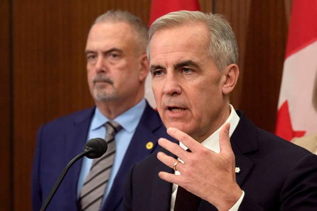 November 26, 2025, Ottawa, On, Canada: Dofasco CEO Ron BÃ dard looks on as Prime Minister Mark Carney speaks during a news conference in Ottawa, Wednesday, Nov. 26, 2025. Ottawa Canada  - ZUMAc35_ 20251126_zaf_c35_075 Copyright: xAdrianxWyldx