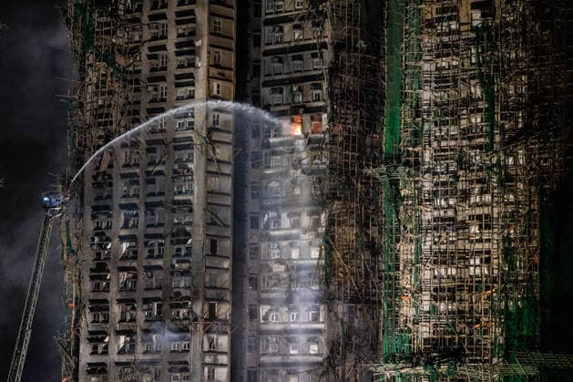 Hong Kong Building Fire A firetruck ladder spraying water onto the apartment building where a major fire engulfs several residential buildings at Wang Fuk Court on November 27, 2025 in Hong Kong. Serval residential building in Wang Fuk Court located in Tai Po District caught fire today, the Hong Kong Fire Department has issued the No.5 fire alarm, the fire at local time 2000 - 65 Dead. (Photo by Vernon Yuen Nexpher Images) Hong Kong