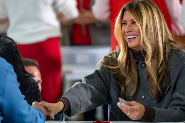 First Lady Melania Trump shakes hands with a volunteer while creating care packages for deployed Service members with Second Lady Usha Vance, the American Red Cross, U.S. Government Cabinet spouses and military spouses at Joint Base Andrews in Prince Georges County, Maryland on Monday, December 1, 2025.  WAP20251201364 BONNIExCASH