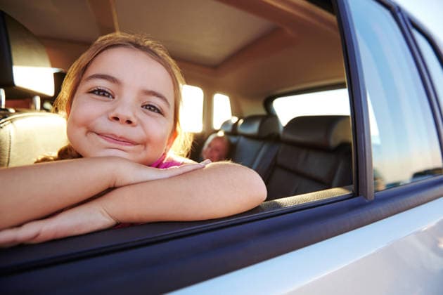 Portrait, child and travel by car window for road trip, holiday or family vacation with girl. Kid, tourism and smile in transport for adventure, journey and happy passenger relax in motor vehicle. model released property released Copyright: xx