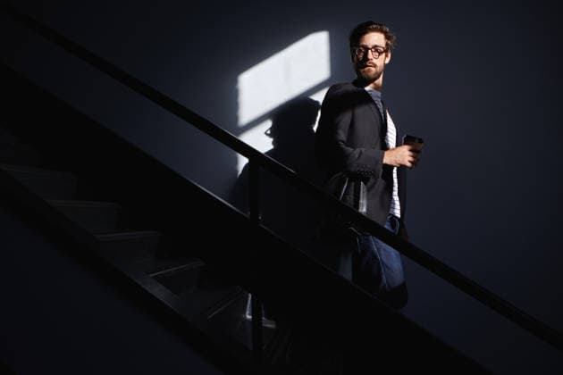 Thinking, businessman and coffee on dark stairway, introspection or mental preparation for work. Calm, morning reflection and thoughtful person with beverage for career goals, walking space or shadow. model released property released Copyright: xx