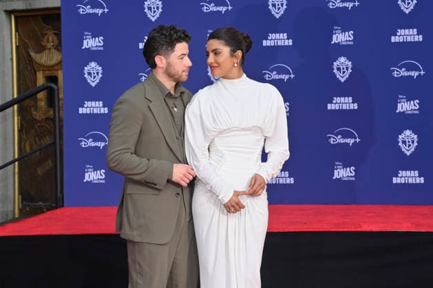 Nick Jonas is joined by his wife Priyanka Chopra at the Jonas Brothers hand and footprint ceremony immortalizing them in the forecourt of the TCL Chinese Theatre (formerly Grauman s) in the Hollywood section of Los Angeles on Wednesday, December 3, 2025.  LAP2025120321 JIMxRUYMEN