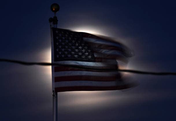 December 4, 2025, Van Nuys, California, USA: An American flag waves from the Santa Ana winds and is light up by the last super moon of 2025 rises from the east above the San Fernando Valley on Thursday. The last full super moon of 2025, known as the Cold Moon, will illuminate the late autumn sky. Van Nuys USA - ZUMAbl1_ 20251204_zaf_bl1_003 Copyright: xGenexBlevinsx
