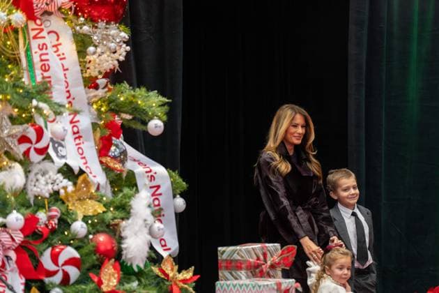 December 5, 2025, Washington, District Of Columbia, USA: First Lady MELANIA TRUMP walks out from behind a curtain hand in hand with two children during her visit to the childrens hospital. Washington USA - ZUMAs365 20251205_znp_s365_001 Copyright: xJoeyxSussmanx