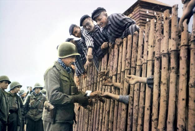 Enlisted Man of Seventh US Army Giving Cigarettes to Liberated Prisoners, Dachau, Germany, Central Europe Campaign, Western Allied Invasion of Germany, April 29,1945  Copyright: xABxArchivesx jtv011171