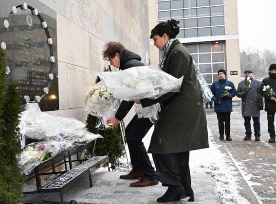 December 6, 2025, Montreal, Pq, Canada: Ecole Polytechnique student association representatives, Gabriel Comby, left, and Imane Chafi lay flowers at a memorial plaque for the victims of the 1989 Ecole Polytechnique massacre in Montreal, Saturday, December 6, 2025. Today marks the 36th anniversary of the shooting by an anti-feminist which left 14 women dead and 13 others injured. Montreal Canada - ZUMAc35_ 20251206_zaf_c35_008 Copyright: xGrahamxHughesx