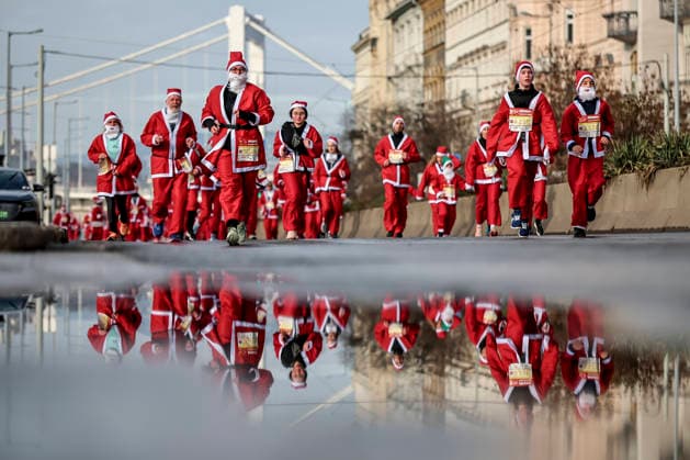 (251208) -- BUDAPEST, Dec. 8, 2025 -- People in Santa Claus costumes participate in the annual Santa Run in Budapest, Hungary, Dec. 7, 2025. The event was held here on Sunday, bringing together about 4,500 participants dressed as Santa Claus to attend, and turning the city center into a joyful sea. (Photo by Xinhua) HUNGARY-BUDAPEST-SANTA RUN DavidxBalogh 