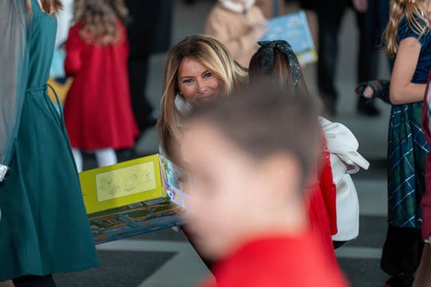 December 8, 2025, Quantico, Virginia, USA: First Lady MELANIA TRUMP holds a toy as she speaks to a little girl during a Toys for Tots event at Marine Corps Base Quantico. Quantico USA - ZUMAs365 20251208_znp_s365_008 Copyright: xJoeyxSussmanx