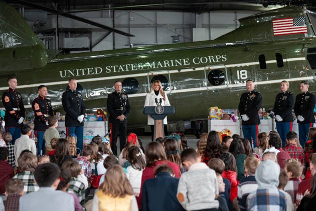 December 8, 2025, Quantico, Virginia, USA: First Lady MELANIA TRUMP smiles at a group of children as she stands in front of a Marine helicopter flanked by Marines in dress uniforms at Marine Corps Base Quantico. Quantico USA - ZUMAs365 20251208_znp_s365_010 Copyright: xJoeyxSussmanx