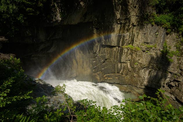 Rainbow over Isel river waterfall in Pragraten Austria sunny summer atmosphere showing dramatic gorge and natural alpine scene Prägraten am Großvenediger Austria