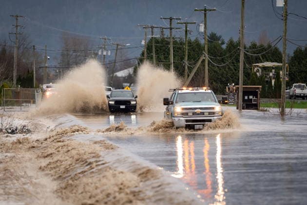 December 11, 2025, Vancouver, Bc, CANADA: Vehicles move through a flooded street in Abbotsford B.C., on Thursday, December 11, 2025. Vancouver CANADA  - ZUMAc35_ 20251211_zaf_c35_149 Copyright: xEthanxCairnsx