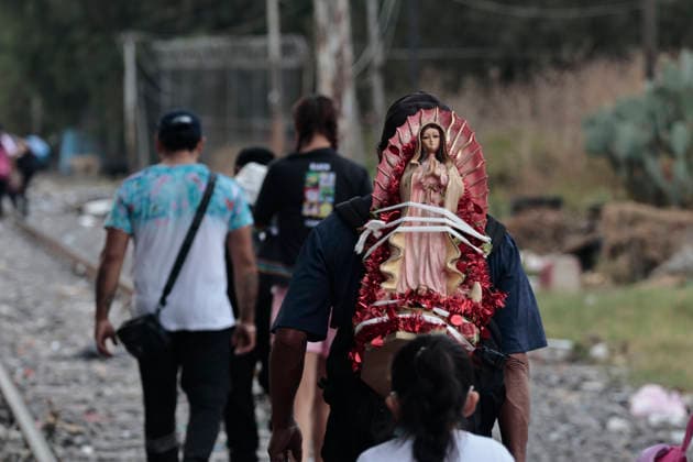 December 11, 2025, Nezahualcoyotl, State Of Mexico, Mexico: Walking with images and statues of the Virgin, pilgrims from ChimalhuacoÂ¡n and Nezahualcoyotl in the State of Mexico are heading to celebrate the Virgin of Guadalupe s birthday at the Basilica on Tepeyac Hill. Hundreds of people, alone or in groups, walk along the railroad tracks that cross past the Neza-Bordo Prison and what was once the largest garbage dump in Latin America. During the six- to eight-hour walk, some people give food as thanks for a miracle they believe the Virgin of Guadalupe has granted them; they also help the pilgrims reach their destination safely. Nezahualcoyotl Mexico - ZUMAp204 20251211_zip_p204_066 Copyright: xJosuexPerezx