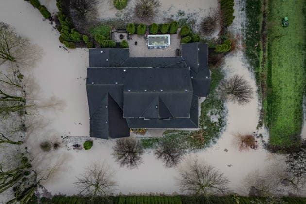 December 12, 2025, Abbotsford, Bc, CANADA: Floodwaters surround a house in Abbotsford, B.C., on Friday, Dec. 12, 2025. Abbotsford CANADA  - ZUMAc35_ 20251212_zaf_c35_052 Copyright: xEthanxCairnsx