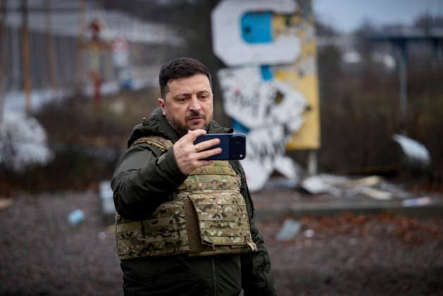 December 12, 2025, Kupyansk, Kharkiv Oblast, Ukraine: Ukrainian President Volodymyr Zelenskyy, takes a selfie in front of the bullet ridden sign for Kupyansk during a visit to the frontlines of the Kharkiv region, December 12, 2025, in Kupyansk, Kharkiv Oblast, Ukraine. Earlier Russian President Putin claimed the city was under Russian control. Kupyansk Ukraine - ZUMAp138 20251212_zaa_p138_011 Copyright: xPoolx UkrainianxPresidentiax