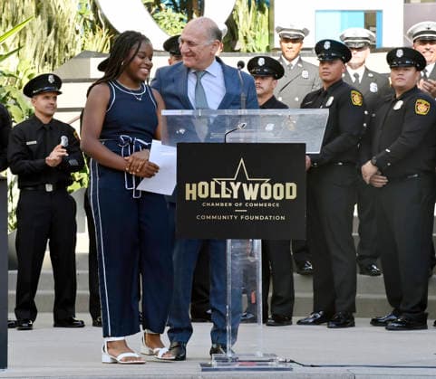 Steven Nissen, President & CEO, Hollywood Chamber of Commerce (R) and Eniola Taiwo participate in an unveiling ceremony honoring the Los Angeles Fire Department with an Award of Excellence star adjacent to the Hollywood Walk of Fame in Los Angeles on Tuesday, December 2, 2025. Taiwo, 14, wrote a letter to the Hollywood Chamber of Commerce suggesting that firefighters who battled the deadly January fires were worthy of a star on the Hollywood Walk of Fame. The letter precipitated the tribute.  LAP2025121218 JIMxRUYMEN