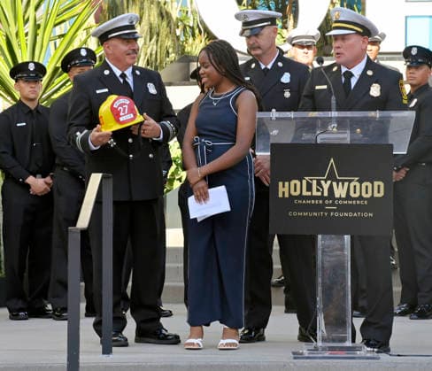 Eniola Taiwo (C) participates in an unveiling ceremony honoring the Los Angeles Fire Department with an Award of Excellence star adjacent to the Hollywood Walk of Fame in Los Angeles on Tuesday, December 2, 2025. Taiwo, 14, wrote a letter to the Hollywood Chamber of Commerce suggesting that firefighters who battled the deadly January fires were worthy of a star on the Hollywood Walk of Fame. The letter precipitated tribute.  LAP2025121220 JIMxRUYMEN