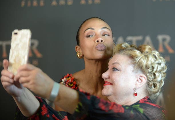 MIAMI, FLORIDA - DECEMBER 12: Zoe Saldana take a selfie with member of the press during the Miami Special Screening of Avatar: Fire and Ash at AMC Sunset Place 24 in Miami, Florida on December 12, 2025. Copyright: xmpi10 MediaPunchx