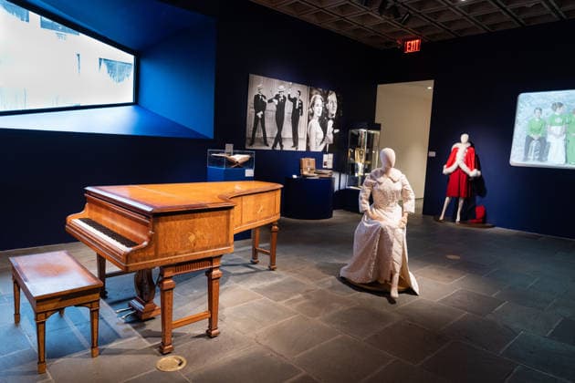 Sotheby s Icons and Bing Crosby Exhibitions press preview Kathryn Crosby Jean Louis Bespoke Christmas ensemble, Jean Louis Ivory Matelasse and Fox Evening Coat and A Sheraton style Satinwood, mahogany and marquetry Grand Piano, part of Kathryn & Bing Crosby collection on view during press preview at Sotheby s Icons and Bing Crosby Exhibitions in New York, NY on December 13, 2025. New York New York United States Copyright: LevxRadin