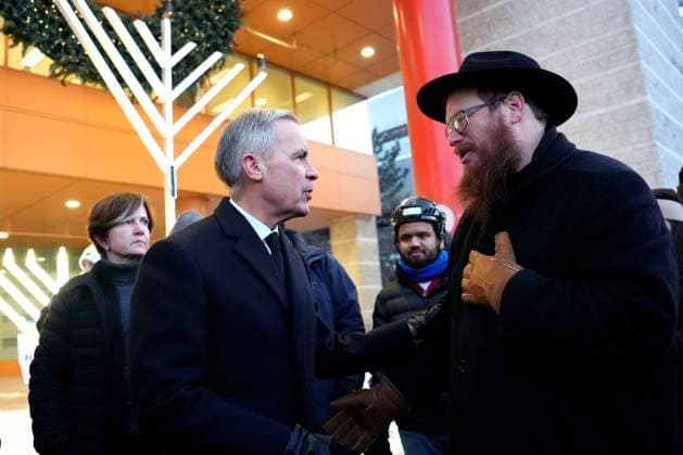 December 14, 2025, Ottawa, On, CAN: Prime Minister Mark Carney speaks with Rabbi Chaim Boyarsky of the Chabad Student Network of Ottawa, after the lighting of the menorah at City Hall in Ottawa to celebrate Hanukkah in the aftermath of a deadly shooting at an event in Sydney, Australia, on Sunday, Dec. 14, 2025. Ottawa CAN  - ZUMAc35_ 20251214_zaf_c35_010 Copyright: xJustinxTangx