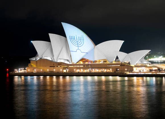 A Hanukkah menorah is projected onto the sails of the Sydney Opera House in memory of the victims of a shooting at Bondi Beach, in Sydney, on Monday on December 15, 2025.  AST2025121506 NSWxPremier sxOffice