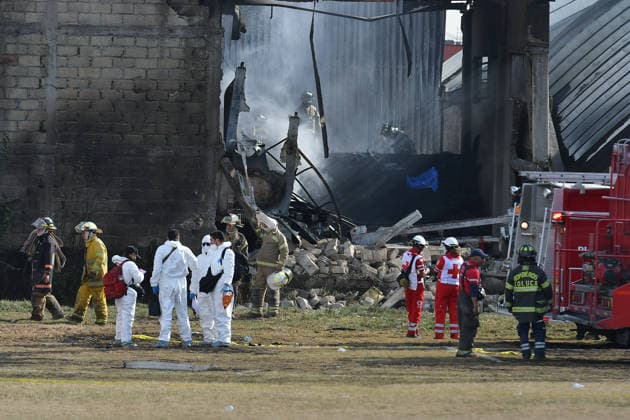 (251215) -- TOLUCA, Dec. 15, 2025 -- Emergency crews work at the aircraft crash site in Toluca, the State of Mexico, central Mexico, Dec. 15, 2025. At least six people were killed Monday after a small aircraft crashed in the municipality of San Mateo Atenco in Mexico s central State of Mexico, local authorities said. (Photo by Xinhua) MEXICO-STATE OF MEXICO-TOLUCA-AIRCRAFT-CRASH ArturoxHernandez 