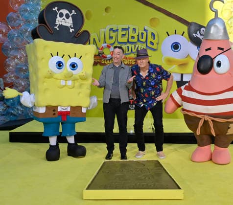 Tom Kenny, the voice of SpongeBob (L) and and Bill Fagerbake, the voice of Patrick participate in a hand and footprint ceremony immortalizing SpongeBob in the forecourt of the TCL Chinese Theatre (formerly Grauman s) in the Hollywood section of Los Angeles on Tuesday, December 16, 2025.  LAP20251216409 JIMxRUYMEN