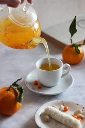 Sea buckthorn tea is poured from a transparent teapot into a cup Russia, Moscow Oblast, Russia R_CTOS251215-1905137-01