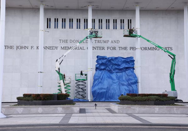 December 19, 2025, Washington, District of Columbia, USA: Workers drop a tarp after adding the name Donald J. Trump to the Kennedy Center for the Performing Arts in Washington, D.C., just a day after the art institution s board voted to change the center s name. The Kennedy Center was built as a living memorial to the 35th president, and it has been generally understood that the power to change its name lies with Congress, which has not acted. Washington USA - ZUMAs337 20251219_znp_s337_014 Copyright: xGentxShkullakux