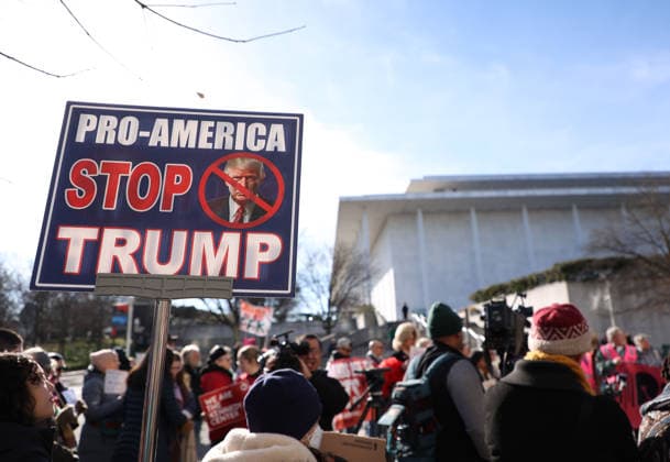 December 20, 2025, Washington Dc, Virginia, USA: Demonstrators hold signs as they protest in front of the John F. Kennedy Memorial Center for the Performing Arts building, in Washington, D.C., USA, on December 20, 2025. Activists opposed adding the name Donald J. Trump to the Kennedy Center for the Performing Arts. Washington Dc USA - ZUMAs337 20251220_znp_s337_010 Copyright: xGentxShkullakux