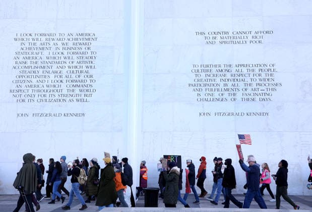 December 20, 2025, Washington Dc, Virginia, USA: Demonstrators hold signs as they march during a protest in front of the John F. Kennedy Memorial Center for the Performing Arts building, in Washington, D.C., USA, on December 20, 2025. Activists opposed adding the name Donald J. Trump to the Kennedy Center for the Performing Arts. Washington Dc USA - ZUMAs337 20251220_znp_s337_022 Copyright: xGentxShkullakux