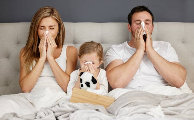 Sick family, bed and blowing nose with tissue for flu, cold or viral infection in isolation together at home. Mother, father and child with fever, sneeze or virus for sinus or influenza in bedroom Sick family, bed and blowing nose with tissue for flu, cold or viral infection in isolation together at home. Mother, father and child with fever, sneeze or virus for sinus or influenza in bedroom., model released, , property released, , 61772570.jpg RECORD DATE NOT STATED