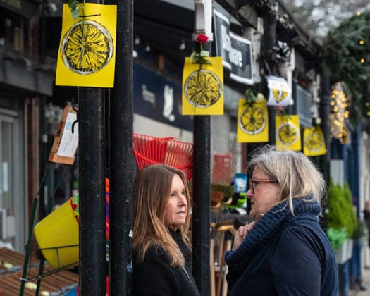 Paintings of a lemon and roses adorn the side of the road ahead of the funeral procession of Gary Mani Mounfield, Bass Player in the Stone Roses and Primal Scream, in Heaton Moor, Stockport on 22 December 2025. The Stone Roses dopted the lemon as a symbol of rebellion and counter-culture, featuring it prominently on their iconic debut album cover. 22 12 2025 Stockport Greater Manchester England Heaton Moor  Copyright: xMattxWilkinsonx