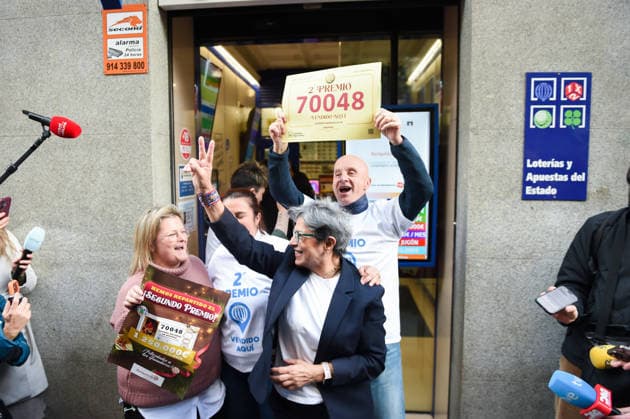 Winners of the Second Prize of the Extraordinary Draw of the Christmas Lottery 2025 celebrate their luck Employees of the administration located in the street of Barquillo 10, celebrate that they have sold the number 70048 corresponding to the Second Prize of the Extraordinary Draw of the Christmas Lottery 2025, on December 22, 2025, in Madrid Spain The 2025 Extraordinary Christmas Lottery Draw consists of 198 series and each series has 100,000 tickets The total amount of the issue is 3,960 million euros and 70 of the issue is destined to prizes 2,772 million euros Each series distributes 14 million euros in prizes. 14 million euros in prizes and a total of 30,301,920 prizes are distributed during a draw that lasts approximately four hours  Copyright: xGustavoxValientex 7183706