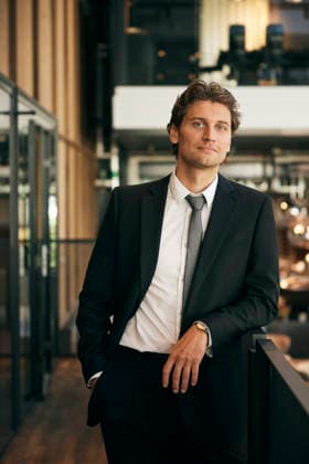 Portrait of confident male lawyer standing with hand in pocket at office corridor Sweden, Stockholm, model released, property released Copyright: xMaskotx , MA121757 MA121757