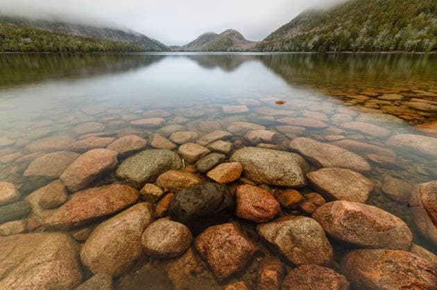 Clear waters of Jordan Pond with boulders and mountains, Acadia Bar Harbor, Maine, United States CR_SSNF251218-1910170-01