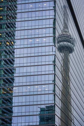 Modern glass skyscraper facade reflecting CN Tower in Toronto, Canada Toronto, Ontario, Canada CR_UGOUSD251217-1909039-01