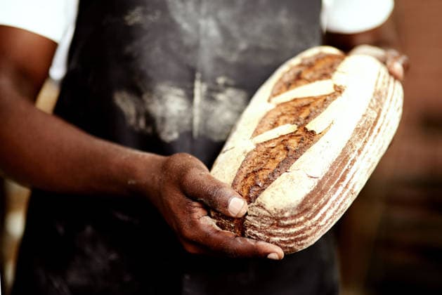 Hands, baker and bread in restaurant or small business as entrepreneur for retail supermarket. Person, pastry chef and baked goods in kitchen with fresh sourdough loaf in bakery, store or coffee shop Hands, baker and bread in restaurant or small business as entrepreneur for retail supermarket. Person, pastry chef and baked goods in kitchen with fresh sourdough loaf in bakery, store or coffee shop., model released, , property released, , 62029668.jpg RECORD DATE NOT STATED