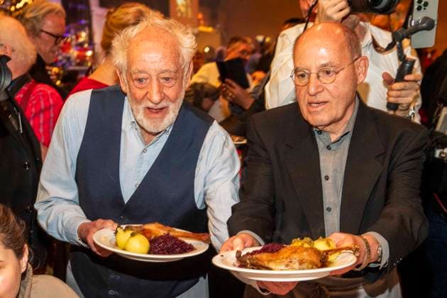 abb: Dieter Hallervorden und Gregor Gysi als Promi Kellner beim Servieren von Teller mit Gaensekeuele Rotkohl und Kloesse bei der 31. Frank Zander Weihnachtsfeier Weihnachtsessen fuer Obdachlose und Beduerftige Menschen 2025 im Estrel Convention Center am 22.12.2025 in Berlin Berlin Deutschland