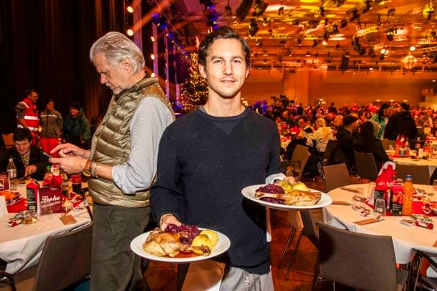 abb: Tim Oliver Schultz als Promi Kellner beim Servieren von Teller mit Gaensekeuele Rotkohl und Kloesse bei der 31. Frank Zander Weihnachtsfeier Weihnachtsessen fuer Obdachlose und Beduerftige Menschen 2025 im Estrel Convention Center am 22.12.2025 in Berlin Berlin Deutschland