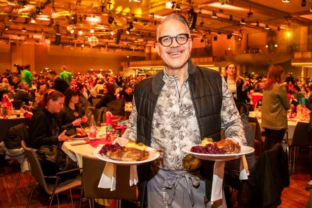 abb: Karsten Speck Schauspieler als Promi Kellner beim Servieren von Teller mit Gaensekeuele Rotkohl und Kloesse bei der 31. Frank Zander Weihnachtsfeier Weihnachtsessen fuer Obdachlose und Beduerftige Menschen 2025 im Estrel Convention Center am 22.12.2025 in Berlin Berlin Deutschland