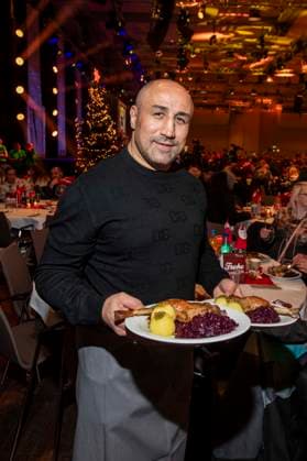 abb: Arthur Abraham ex Boxer als Promi Kellner beim Servieren von Teller mit Gaensekeuele Rotkohl und Kloesse bei der 31. Frank Zander Weihnachtsfeier Weihnachtsessen fuer Obdachlose und Beduerftige Menschen 2025 im Estrel Convention Center am 22.12.2025 in Berlin Berlin Deutschland