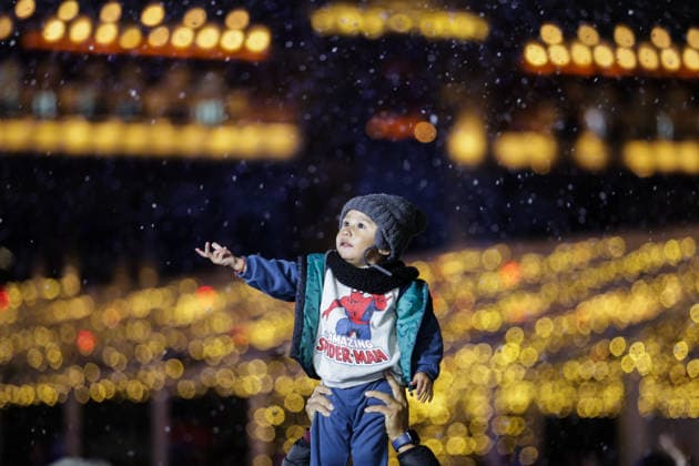 (251223) -- MEXICO CITY, Dec. 23, 2025 -- A child plays with artificial snow during a winter lights festival at the Zocalo square in Mexico City, Mexico, Dec. 22, 2025. A winter lights festival is held here to welcome the arrival of 2026. ) MEXICO-MEXICO CITY-WINTER LIGHTS FESTIVAL FranciscoxCanedo 