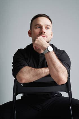 Thoughtful portrait of man in classic suit sitting in minimalist studio model released, Symbolfoto, EKHF00125
