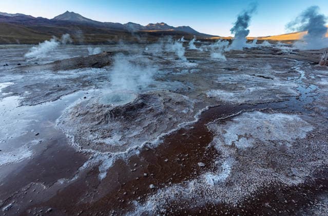Steam rising from geysers at El Tatio geothermal field at sunset, FCF02332