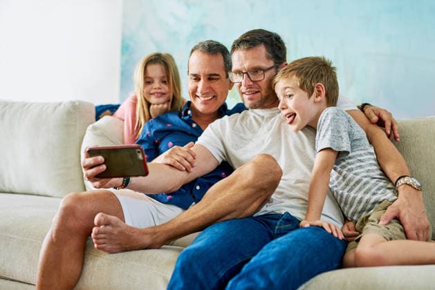 Gay dad, children and selfie in home on sofa with hug, care and connection with memory in living room. Father, kids and lgbtq parents with funny face, care and embrace on couch in lounge at house Gay dad, children and selfie in home on sofa with hug, care and connection with memory in living room. Father, kids and lgbtq parents with funny face, care and embrace on couch in lounge at house., model released, , property released, , 62489854.jpg RECORD DATE NOT STATED