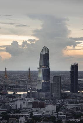 Creative Highlights World Aerial view of KingBridge tower alongside the iconic landmark of Bhumibol Bridge with Dramatic sky background before Sunset. Bangkok, Thailand - 13 Oct, 2024 - Aerial view of KingBridge tower alongside the iconic landmark of Bhumibol Bridge with Dramatic sky background before Sunset. Stunning At Twilight skyline of bangkok business district with Skyscrapers, use it as your wallpaper, poster and Space for text, Selective focus., 62774594.jpg RECORD DATE NOT STATED