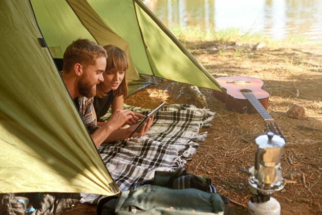 Couple, rest and tablet in tent for camping with communication, streaming online and bonding together. Smile, people and love with digital for entertainment, social media and travel vacation of date Couple, rest and tablet in tent for camping with communication, streaming online and bonding together. Smile, people and love with digital for entertainment, social media and travel vacation of date., model released, , 62974574.jpg RECORD DATE NOT STATED