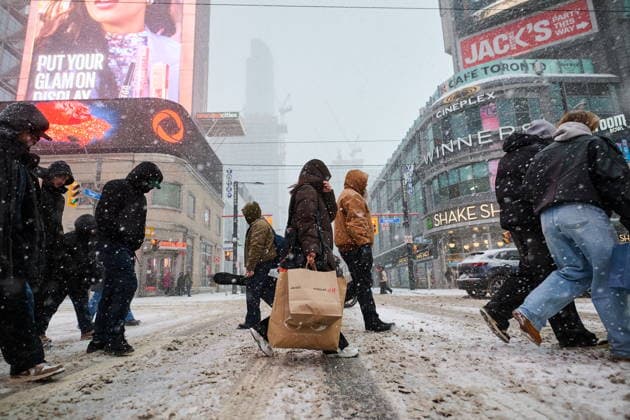 December 26, 2025, Toronto, On, Canada: Shoppers walk through a snow storm as they exit Eaton Centre on Boxing Day in Toronto, on Friday, Dec. 26, 2025. Toronto Canada  - ZUMAc35_ 20251226_zaf_c35_027 Copyright: xSammyxKoganx